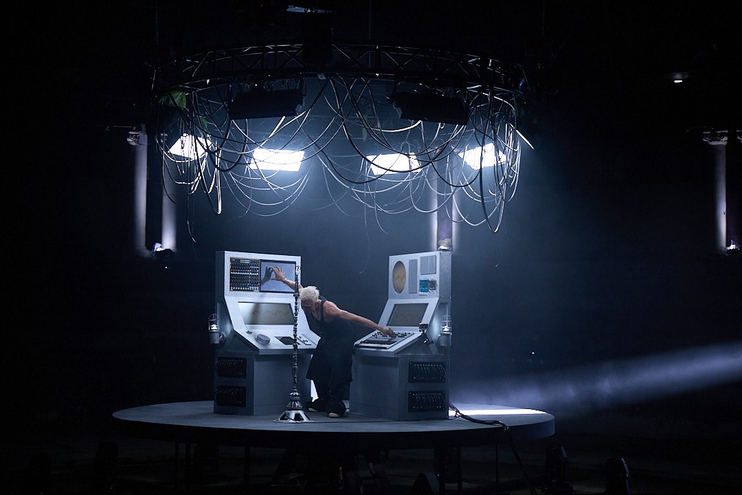 Wide front view of M07 between two custom instrument consoles beneath suspended lights and cables